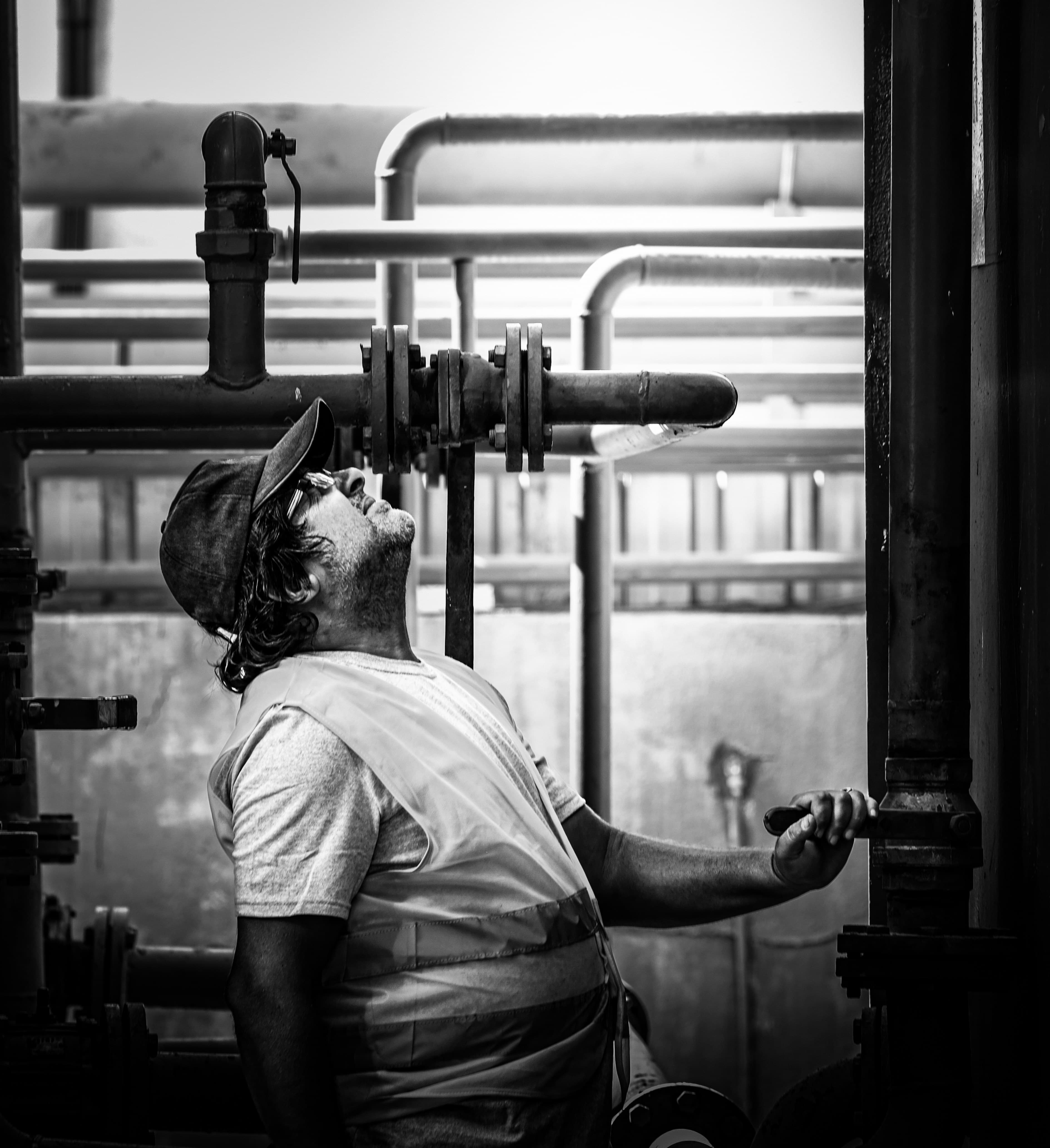 Three Sixty Plumbing And Renovations crew member inspecting industrial pipework on a jobsite